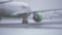 Defocused shot of airliner driving to parking after landing at the airport, view on snowy winter day