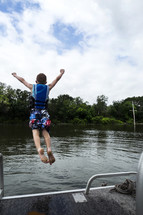 child jumping into a lake 