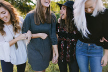 friends standing together outdoors laughing 