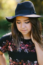 teen girl in a hat outdoors 