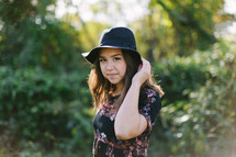 portrait of a teen girl in a hat outdoors 