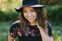 a teen girl in a hat 