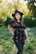 portrait of a teen girl standing outdoors 