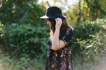 teen girl in a hat standing outdoors 