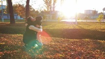Mom and son hug in autumn park