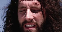 Jesus' face as he is being flogged