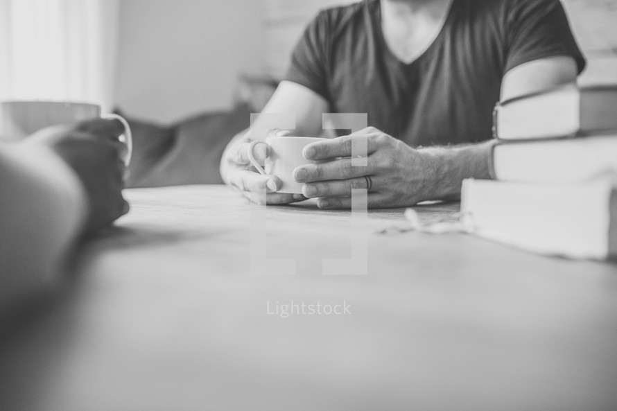 men's group sitting around a table studying the Bible 
