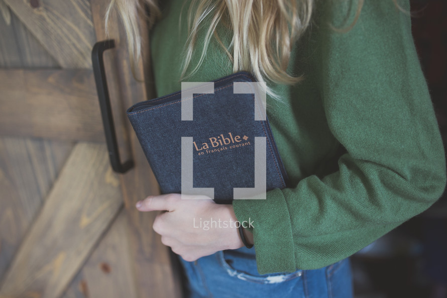 a girl holding a Bible 