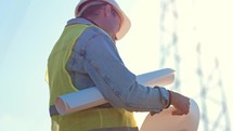 Industry energy business concept. Silhouette electrical engineer a working near tower with electricity at sunset time. Electrical worker inspect voltage electricity pylon. Power generation industry.