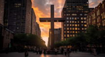 large cross in the middle of a busy city with buildings surrounding