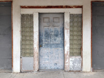 entry area with a weathered wooden door