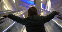 Child getting upstairs on escalator