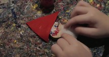 Kid making Santa Claus craftwork