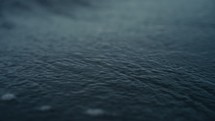 Water running over the sand of a tropical beach at dusk