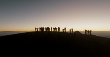 Hikers At Volcan Acatenango During Dawn With Volcán de Fuego At Background Near Antigua, Guatemala. Aerial Drone Shot