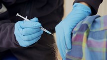 Paramedic giving people the COVID-19 vaccine injection during the vaccination operation
