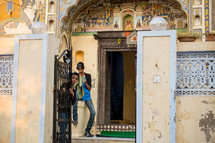 children standing in a doorway in Mandawa, India 