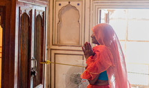 a woman praying in India 