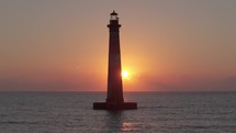 A lighthouse on the  Atlantic Ocean coast of South Carolina during sunrise 