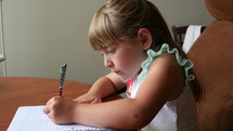 A cute little girl drawing a picture