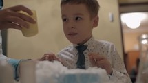 Boy watching reaction of mixing dry ice and liquid nitrogen Fun with chemistry