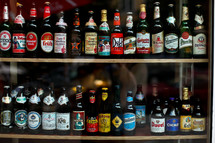 Bottles of beer lined up on two shelves