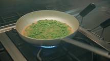 Tagliatelle Green Colored Pasta Cooking In The Pan Of A Restaurant
