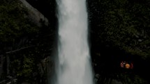 Drone shot of Tourists Visiting The Majestic Pailon del diablo Waterfall In Baños de Agua Santa, Ecuador.