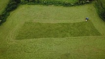 Aerial View of Tractor Cutting Silage / Hay in County Wicklow