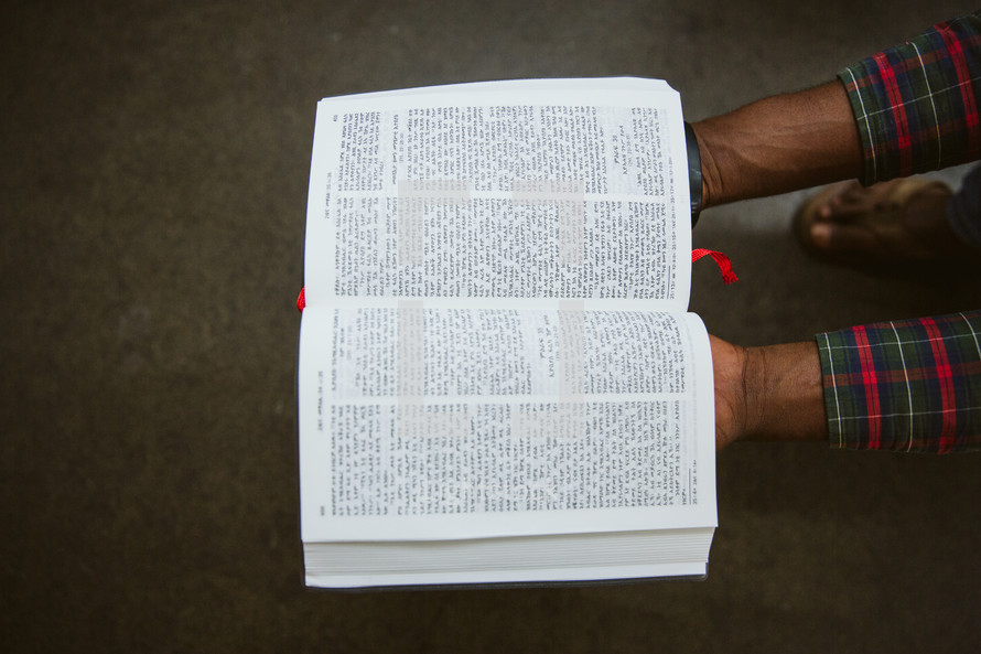 man holding open a German Bible