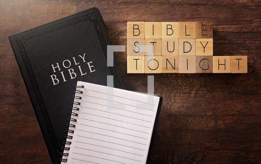 Bible and notebook on a wood background - Bible study tonight 