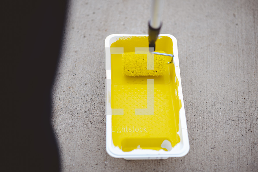 yellow paint in a paint pan 