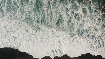 Aerial View Of Foamy White Waves Crashing On the beach