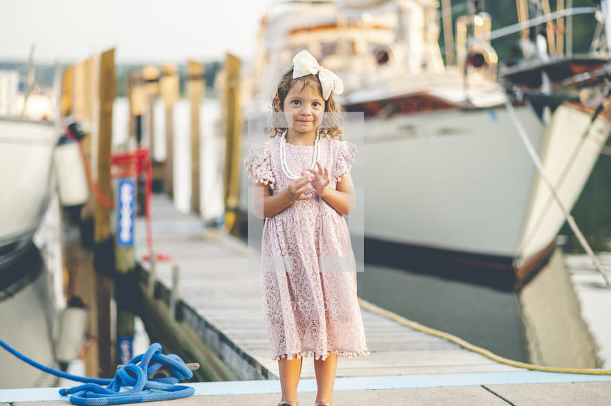 portrait of a little girl on a dock 