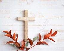 Cross and autumn leaves on a white background