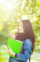 student holding an apple 