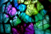 stained glass abstract with bokeh and sense of depth looking through some blurred imagery to detailed glass beyond