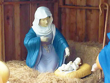 Mary and Jesus in outdoor nativity scene on hay
