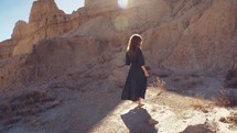 a woman twirling in the badlands 
