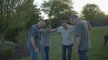 men praying outdoors 
