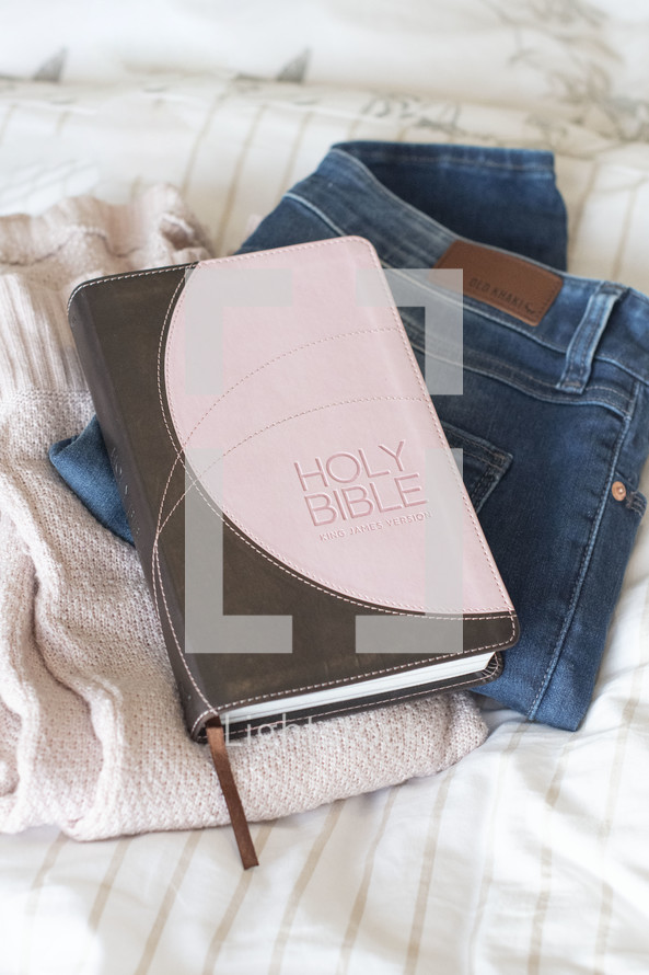 Bible on pile of clothes, getting ready with Jesus 