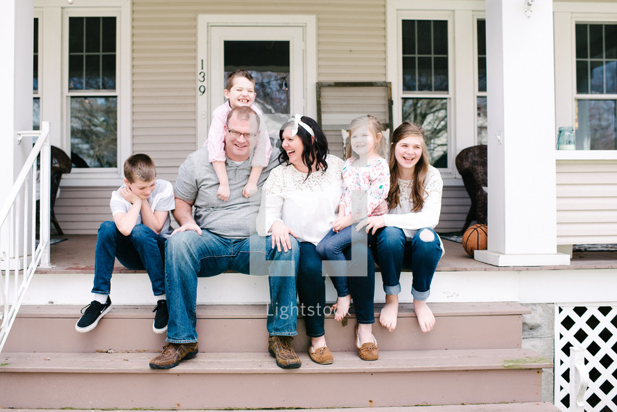 family portrait on a front porch steps 
