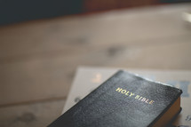 a Bible on a wood table 