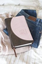 Bible on pile of clothes, getting ready with Jesus 