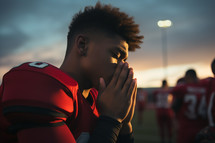 football player praying before a game