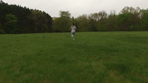 a man running through a field 