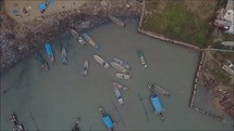 aerial drone flight over the Philippines - boats in a fishing village 
