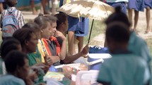school kids eating in Papua New Guinea 