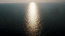 Aerial shot of Glistening Water With Sunlight Reflection at the beach. 