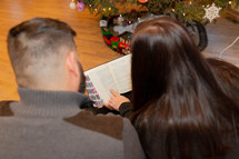 family reading a Bible at Christmas